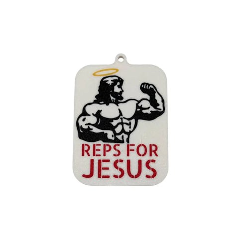 The Reps for Jesus Weightlifting Christmas Ornament by Chatelet Manufacturing features a cartoon strongman with long hair, halo, and flexed arms above “REPS FOR JESUS” in bold black and red—perfect for Christian fitness fans. Made in the USA.