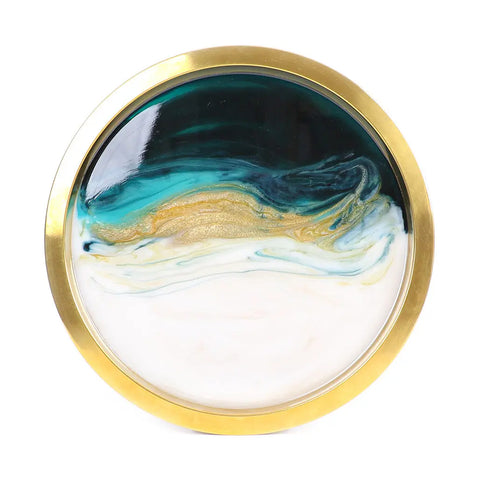 A round tray with a gold rim featuring a swirling abstract teal, gold, and white design—created using ArtResin’s ResinTint Complete Set BUNDLE of 16 colors to evoke ocean waves.