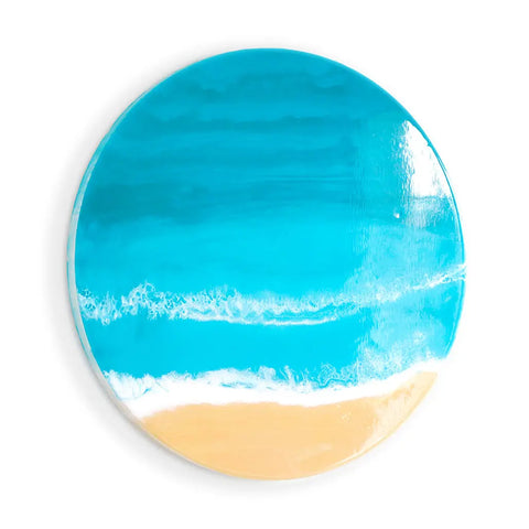 A round artwork made with the ArtResin ResinTint Complete Set BUNDLE (16 Colors), showing a beach from above with sand, white waves, and blue ocean water on a white background.