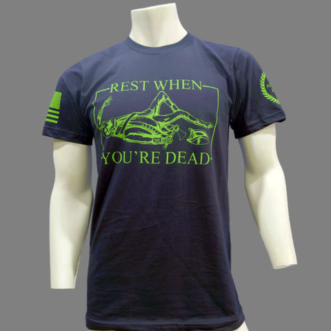 The American Lictor T-Shirt: Rest When Youre Dead features neon green text and a graphic of a person lying down with mountains, plus flag and emblem sleeve accents—motivational black apparel for an active lifestyle.