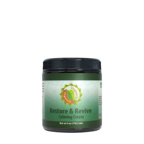 A jar of Taspens Organics Restore & Revive Calming Cream for sensitive skin features a green label, black lid, and product details (4 oz / 118.3 mL) on a white background. Premium American-made skincare.