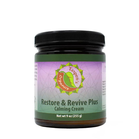 A 9 oz jar of Taspens Organics Restore & Revive Calming Cream PLUS features a brown body, black lid, and green-purple label with the product name and logo—ideal for natural skincare with organic essential oils.