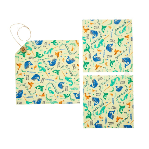 The Lunch Pack by Bee’s Wrap includes three reusable, washable wraps with sea animal designs—whales, dolphins, and turtles—in blue, green, and orange on cream. One wrap has a string-and-button closure. Perfect for eco-friendly storage.