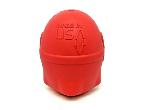 The Rocketman Durable Rubber Treat Dispenser & Chew Toy by SodaPup is a red, dome-shaped chew toy with MADE IN USA embossed text and an upward arrow, shown on a white background.