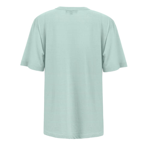 Rocky Mountain Juniper - Sky Blue T-Shirt by Fireside Pine shown from the back on a white background. Made from soft combed cotton, it features an oversize fit and a minimalist design with no visible patterns or logos.