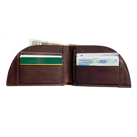 The Rogue Industries Rogue Front Pocket Wallet - Allagash Tan, shown open against a white background, displays cash, credit cards, and a Maine driver’s license in its compartments.