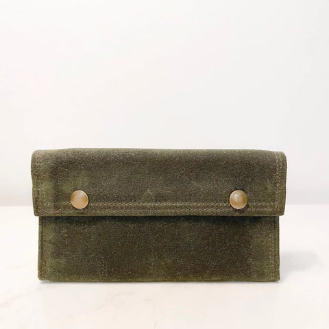 The Rogue Industries Rogue River Fly Fishing Wallet is a rectangular olive green velvet clutch inspired by a waxed canvas fly wallet, featuring two round beige buttons on the front flap, shown against a plain white background.