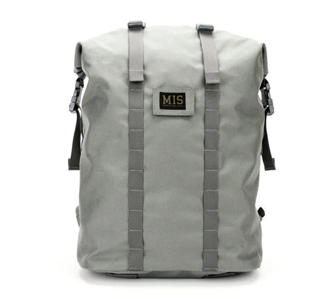 The MIS Roll Up Backpack - Foliage is a durable Cordura Nylon 30L laptop backpack featuring two vertical front straps, side buckle closures, and a front MIS patch label—perfect for daily use with minimalist style.