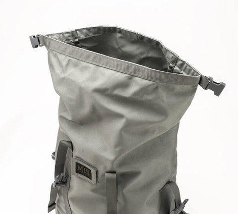 The MIS Roll Up Backpack - Foliage is a gray 30L Cordura Nylon laptop backpack with side-release buckles and a visible MIS patch, shown standing upright on a plain white background.