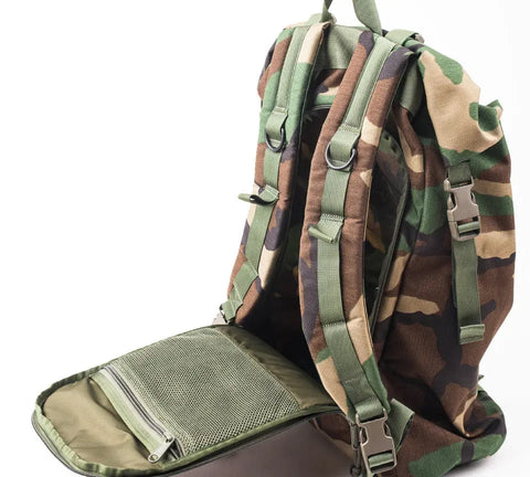 The MIS Roll Up Backpack - Woodland Camo features durable Cordura Nylon, padded shoulder straps, a front compartment with an interior mesh zip pocket, and a heavy-duty YKK zipper, all shown against a plain white background.