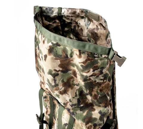The MIS Roll Up Backpack - Covert Woodland features a spacious, open-top Cordura Nylon design with green, brown, and beige camouflage, green straps, and side buckle. Made in the USA for durability—ideal for outdoor or military use.