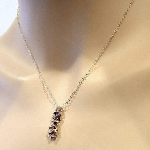 The Super Sparkly Crystal Rock Candy Beaded Rose Gold Crystal Bar Necklace by Alexa Martha Designs features a shimmering bar of crystals, reminiscent of Swarovski designs, elegantly displayed on a mannequin neck.