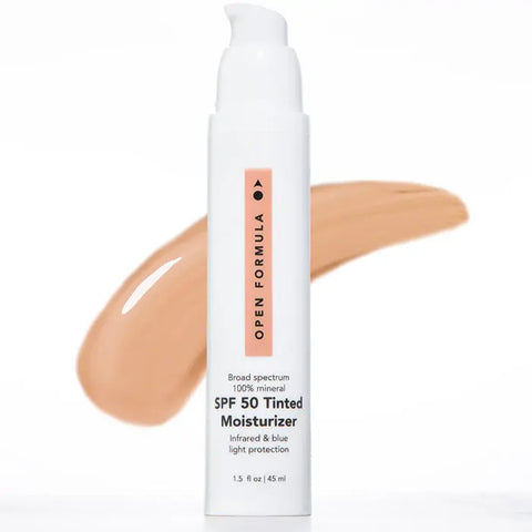 A pump bottle of Open Formula SPF 50 Tinted Moisturizer with a bronze tint is shown before a beige smear, highlighting its broad spectrum mineral sun protection.