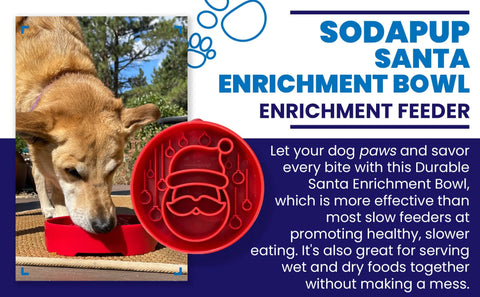 A dog eats from the SodaPup Santa Design EBowl, a durable enrichment slow feeder bowl for dogs that promotes healthy eating and is suitable for both wet and dry foods.