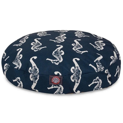 The Majestic Pet Sea Horse Round Dog Bed features a navy blue design with white seahorse prints, a small red logo tag, and a washable, removable cover for easy cleaning.