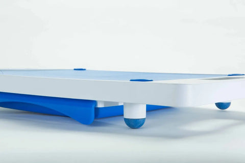 A close-up of the Karving King Set of 2 Dripless Cutting Boards 2 in 1 System shows a white and blue rolling platform with round swivel wheels, designed to support the boards, set against a plain white background.