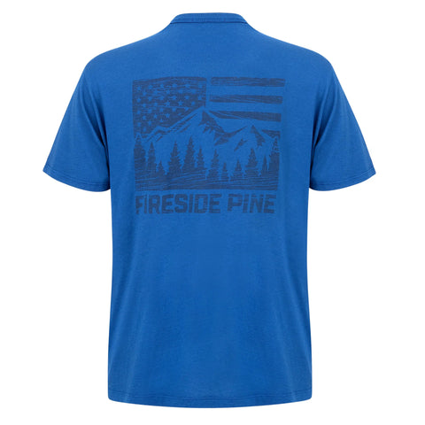 The Fireside Pine Shore Pine - Navy Peony is a relaxed fit T-shirt made from sustainable Modal, featuring a back graphic with an American flag, mountain range, pine trees, and FIRESIDE PINE text.
