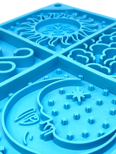 Close-up of the SodaPup Sky Design eMat Enrichment Lick Mat, a blue sensory board with raised sun, clouds, moon, and stars—ideal for soothing dogs and promoting digestive health.