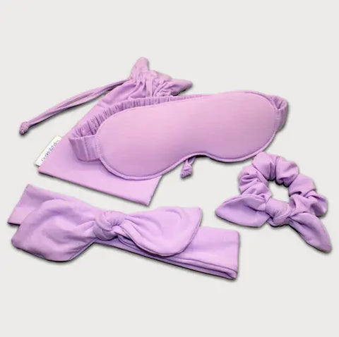 Goodnighties Accessories Value Pack: a lavender sleep mask, scrunchie, bow headband, and matching pouch—all sleepwear essentials arranged on a light background.
