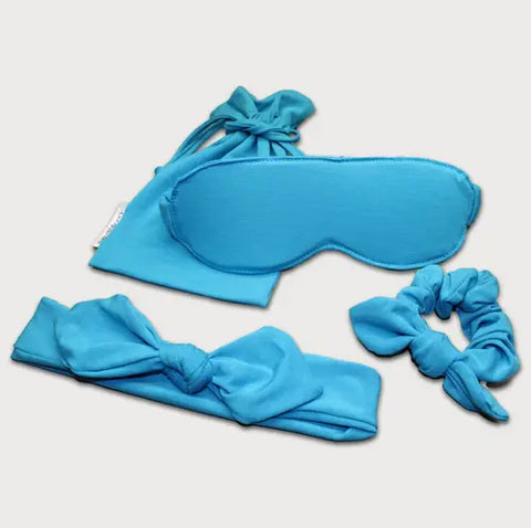The Goodnighties Accessories Value Pack includes blue sleepwear essentials—a sleep mask, scrunchie, knotted headband, and matching drawstring pouch—perfectly displayed on a light background.