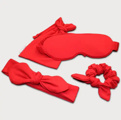 The Goodnighties Accessories Value Pack features red essentials—a bow headband, eye mask, scrunchie, and matching pouch—perfect sleepwear accessories displayed on a light background.