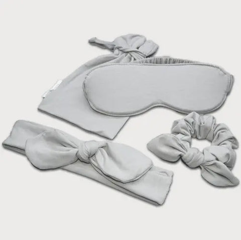 Introducing the Goodnighties Accessories Value Pack: light gray sleepwear essentials—sleep mask, drawstring pouch, knotted headband, and scrunchie—presented on a white background.