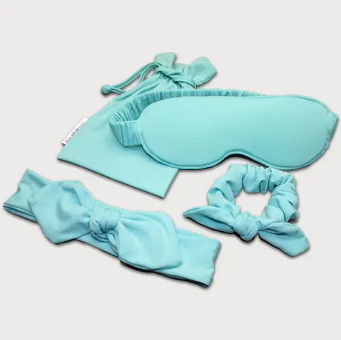 The Goodnighties Accessories Value Pack features a light blue sleep mask, matching scrunchie, bow headband, and small drawstring pouch—perfectly arranging your sleepwear essentials on a crisp white background.