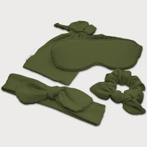 The Goodnighties Accessories Value Pack includes green sleepwear essentials: an eye mask, a bow headband, a scrunchie, and a small drawstring pouch—all crafted from matching fabric.