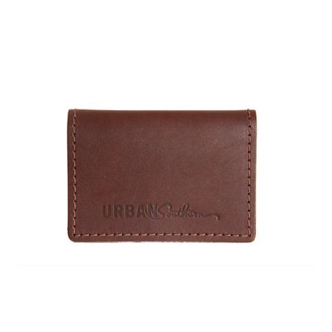 The Urban Southern Bifold Card Wallet is a brown full-grain leather accessory with visible stitching and Urban Southern embossed on the front, blending American-made quality craftsmanship with timeless style.