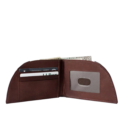 The Football Leather Front Pocket Wallet by Rogue Industries is shown upright against a white background, displaying its brown Horween leather, credit cards, transparent ID slot, and a US dollar bill in the cash compartment.