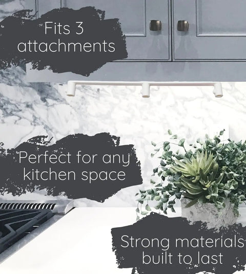 A modern kitchen with gray cabinets, marble backsplash, and a green plant showcases the Chatelet Manufacturing Slim Profile Mixer Organizer Mount—made in the USA, fits all Kitchen Aid mixer attachments, and saves space on your wall or under cabinets.