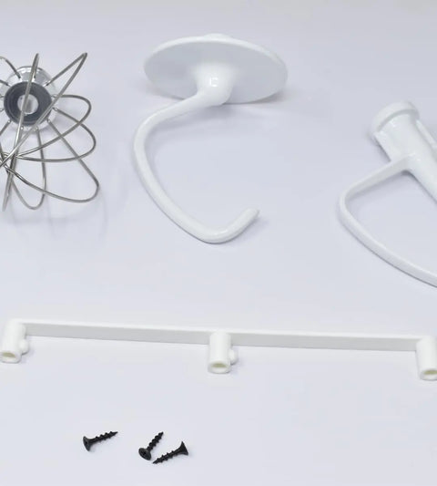 Three mixer attachments, a white Slim Profile Mixer Organizer Mount by Chatelet Manufacturing, and screws are displayed, highlighting this USA-made space-saving solution for Kitchen Aid Mixer accessories, mountable on walls or under cabinets.