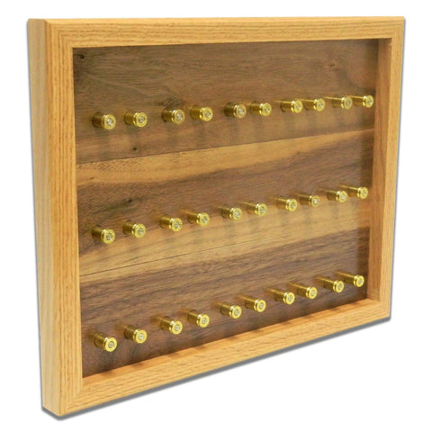 The ORIGINAL Brass Casing Challenge Coin Display - Small by Legacies of America Woodworking Company features a light wood American-made frame, glass front, and four rows for brass bullet casings with a dark wood grain back panel.