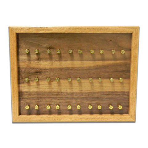 The ORIGINAL Brass Casing Challenge Coin Display - Small by Legacies of America Woodworking Company features a glass-front, wood case with three neatly arranged rows of bullet casings set against a rich wood grain background.