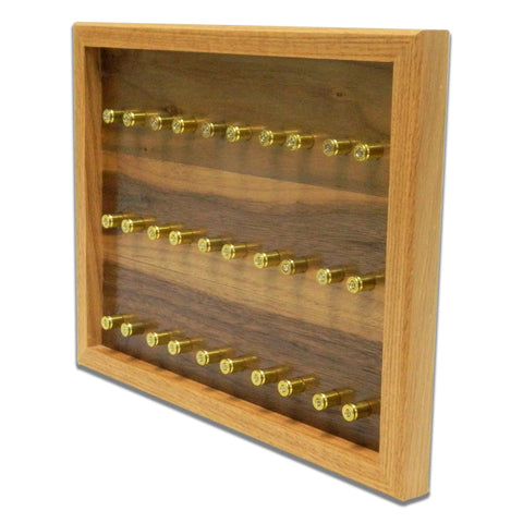 The ORIGINAL Brass Casing Challenge Coin Display - Small by Legacies of America Woodworking Company features three rows of upright brass casings in a wooden, glass-front case. Proudly American made for lasting quality and craftsmanship.