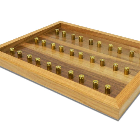 The ORIGINAL Brass Casing Challenge Coin Display - Small by Legacies of America Woodworking Company holds 28 spent brass casings in a grid, with a light wood frame, dark wood base, clear cover, and American Made craftsmanship.