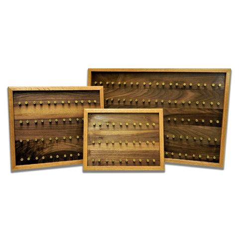 The ORIGINAL Brass Casing Challenge Coin Display - Small by Legacies of America Woodworking Company is a veteran-built, American-made rack featuring evenly spaced brass pegs against a white background.