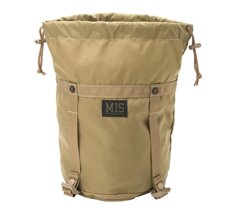 The MIS Compression Stuff Sack Small in Coyote Tan features durable Cordura nylon, a drawstring closure, two vertical straps, a stitched rectangular MIS patch on the front, and a rounded bottom.
