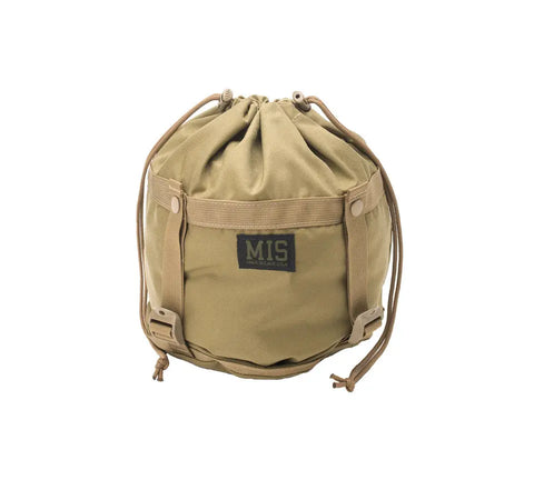 The MIS Compression Stuff Sack Small in Coyote Tan features a drawstring closure, side straps, and a black MIS label on the front. Its shown standing upright against a white background.