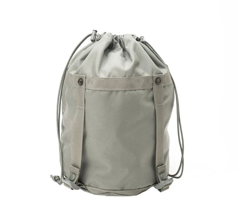 The MIS Compression Stuff Sack Small in foliage is a light grey, water-resistant Cordura nylon backpack with a cylindrical 9L shape, two side buckle straps, and a front pocket with two buttons, shown against a white background.
