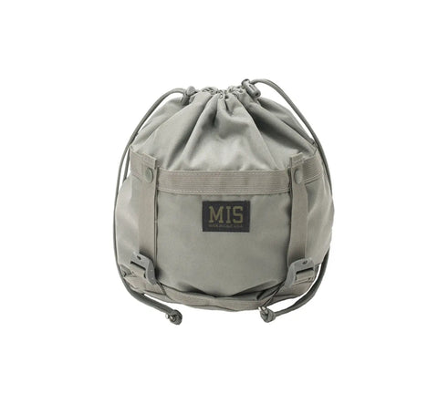 The MIS Compression Stuff Sack Small in Foliage is a 9L utility bag with adjustable straps, a front flap, and a yellow MIS logo patch on black. Photographed against a white background.