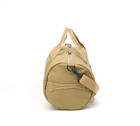 The MIS Training Drum Bag Small in Coyote Tan, made in USA from Cordura nylon, stands upright with its round end facing front, showing a zipper, carrying handles, and adjustable shoulder strap against a white background.