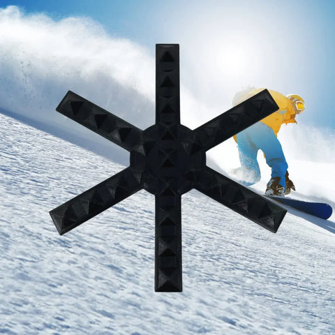 A snowboarder in a yellow jacket and blue pants rides down a snowy slope under bright sun, with the Chatelet Manufacturing Snowboard Stomp Pad—Snowflake Spike Pattern—superimposed for better grip and adhesion.