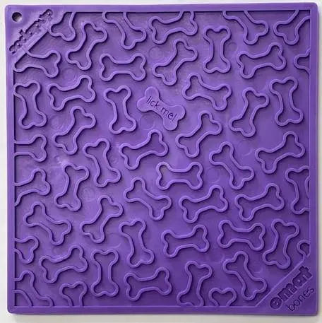 The Bones Design EMat Enrichment Lick Mat by SodaPup is a purple silicone mat with raised bone shapes and lick me! in the center, designed to promote healthy licking habits for dogs during treat time.