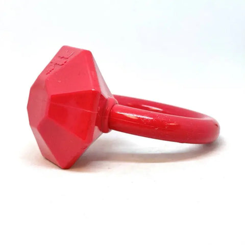 The SodaPup Diamond Ring Durable Teething Ring is a large, red, faceted dog chew toy resembling a costume jewelry ring; its veterinarian approved and featured on a plain white background.