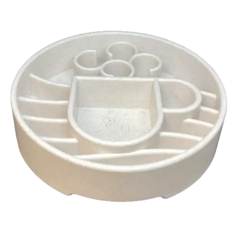 The SodaPup Java Design EBowl Enrichment Slow Feeder Bowl for Dogs is a round, light-colored plastic bowl with raised maze-like sections and a central paw print, designed to slow eating and provide enrichment.