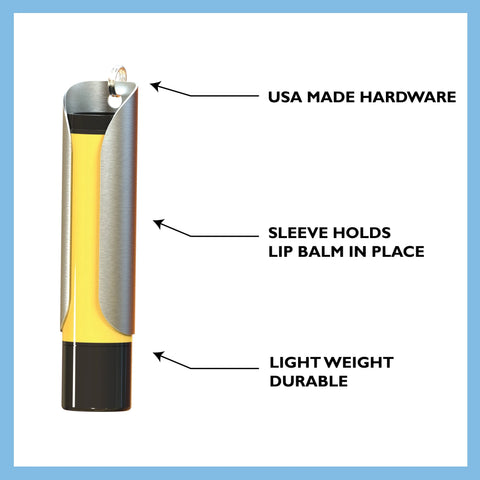 The Tallac House Solid Brass Keychain Holder with Dial Protection, made in the USA, securely grips a yellow and black lip balm tube. A durable brass ring and lightweight design ensure a secure fit and long-lasting use.
