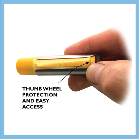 A hand holds a Tallac House Lip Balm Solid Metal Keychain Holder with yellow cap and dial protection. The tube shows an arrow and Thumb wheel protection and easy access. Blue border. Made in USA by Tallac House.