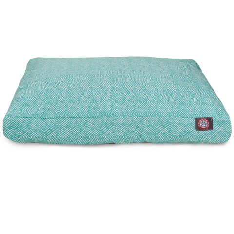 The Majestic Pet South West Rectangle Dog Bed is teal with a white chevron pattern, features a removable cover for easy cleaning, and has a small logo patch sewn on the front corner.