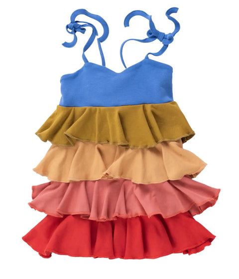 The Girls Twirl Dress by Spiritex | Sustainable Apparel is a colorful, sleeveless organic cotton rainbow dress for kids with blue, yellow, peach, pink, and red ruffled layers and tie straps. Proudly made in the USA.